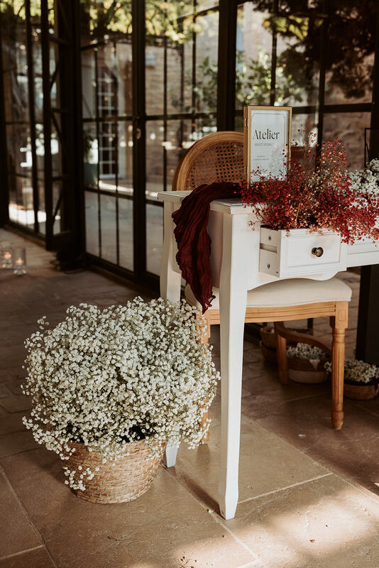 Creative workshop setup with baby’s breath and red flowers – elegant Provence-style bridal shower decor